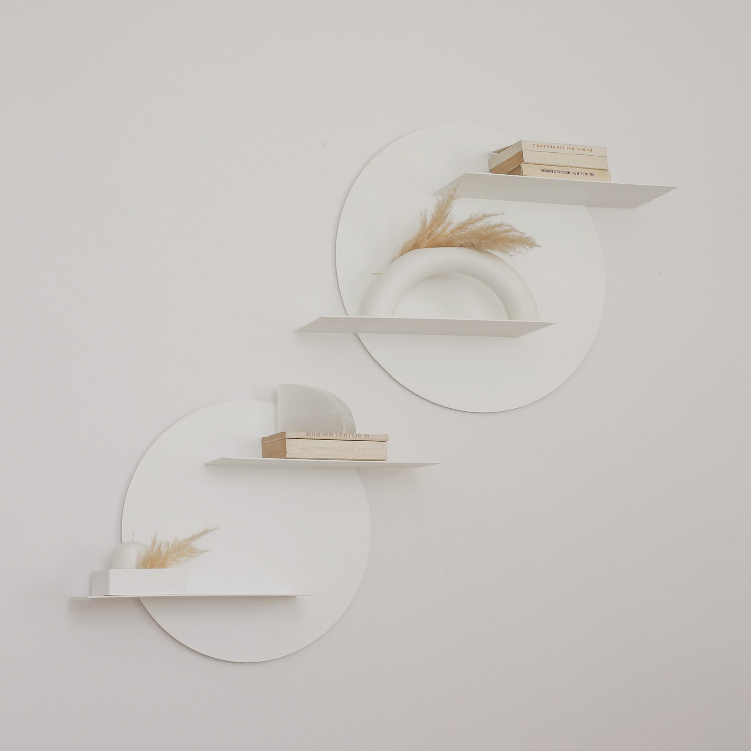 two white round designer wall shelves on white wall and boho decoration