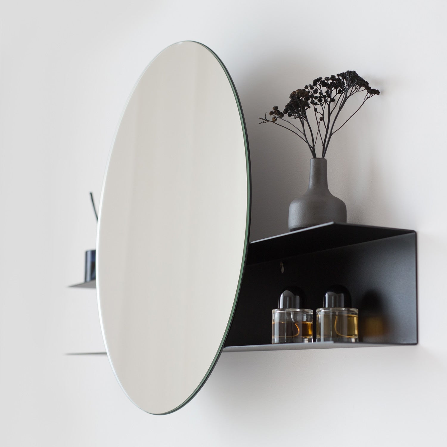 round wall mirror with a shelf
