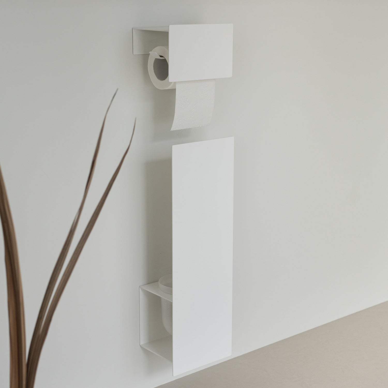 modern white toilet brush holder and toilet paper holder on white tiles