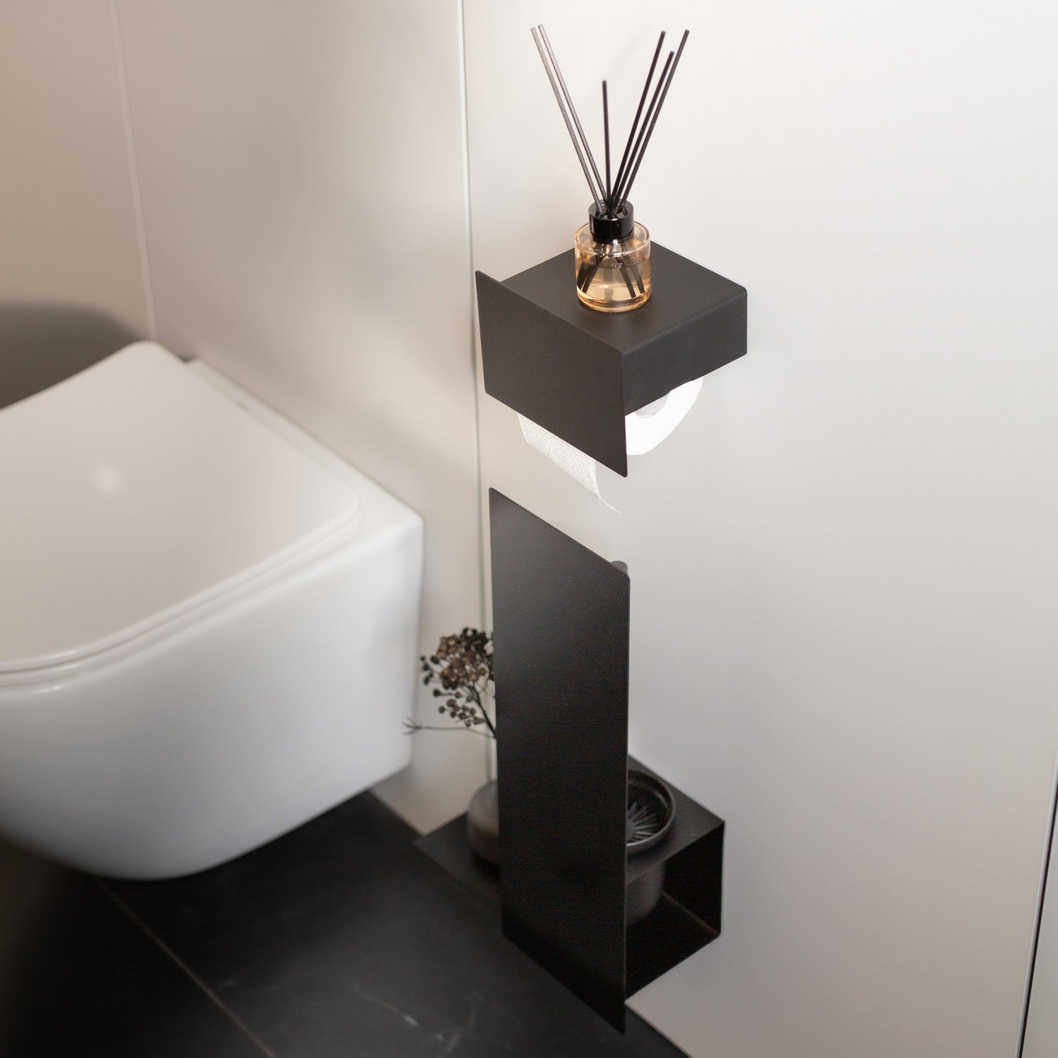 Black minimalist toilet set on grey tiles