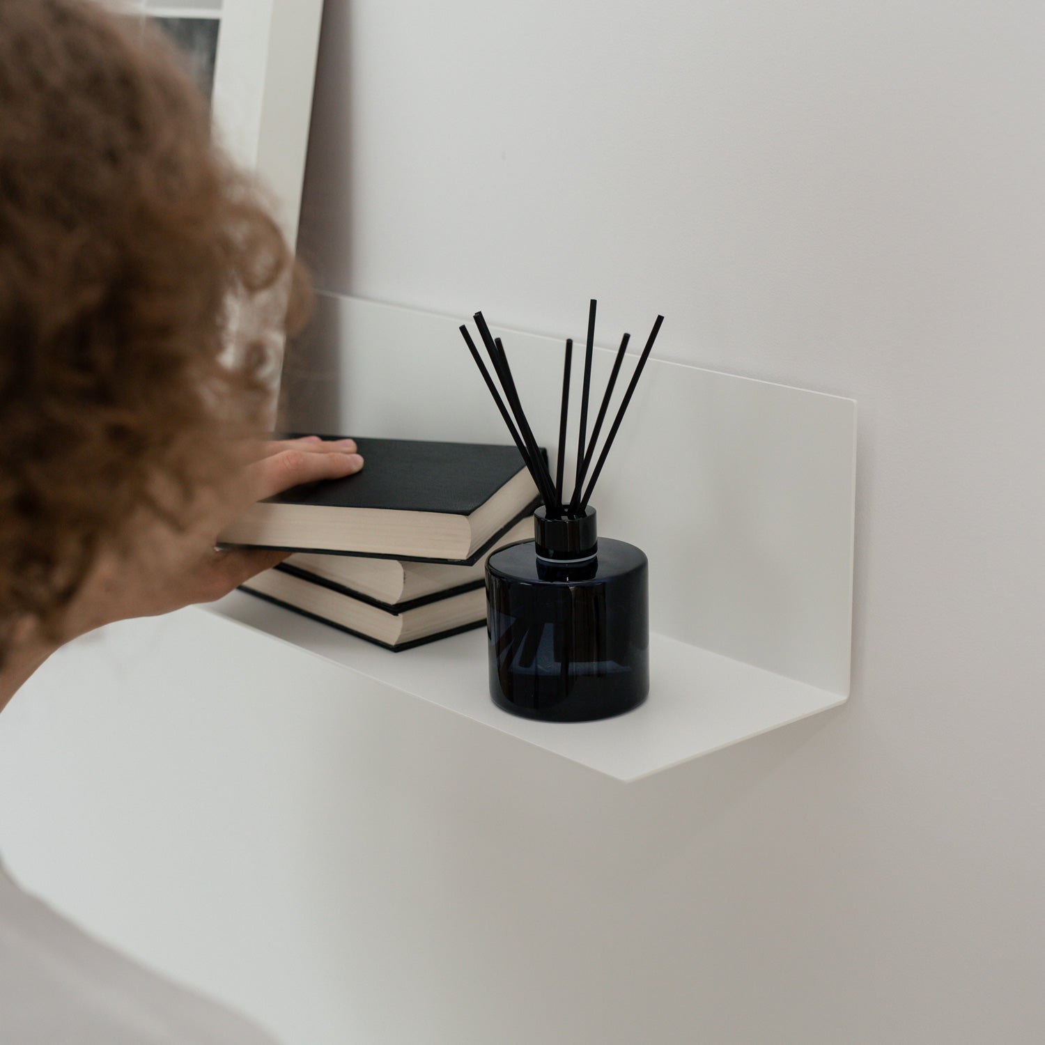 White minimalist wall shelf with books