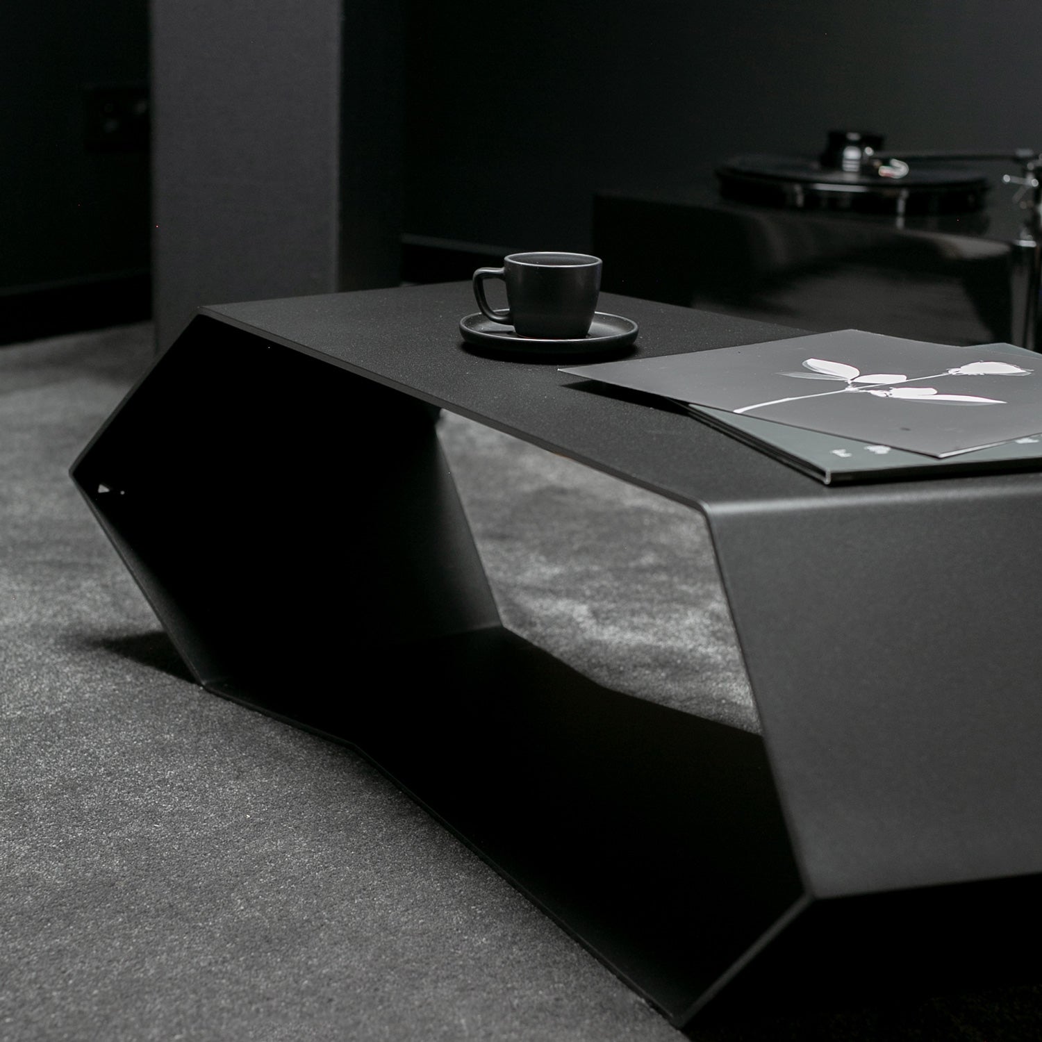 Modern coffee table with a cup and saucer on a dark surface