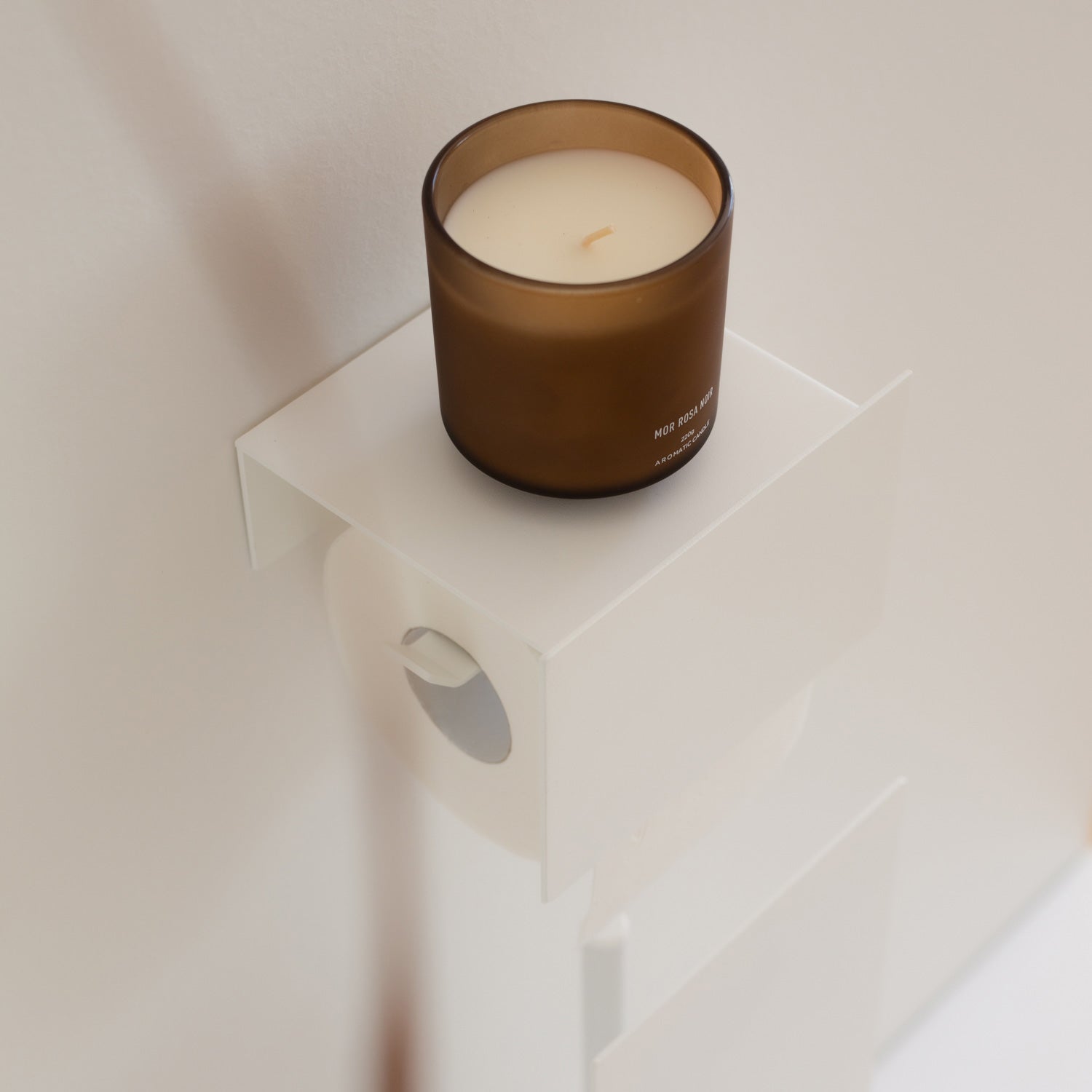 white toilet paper holder tape mounted on white tiles
