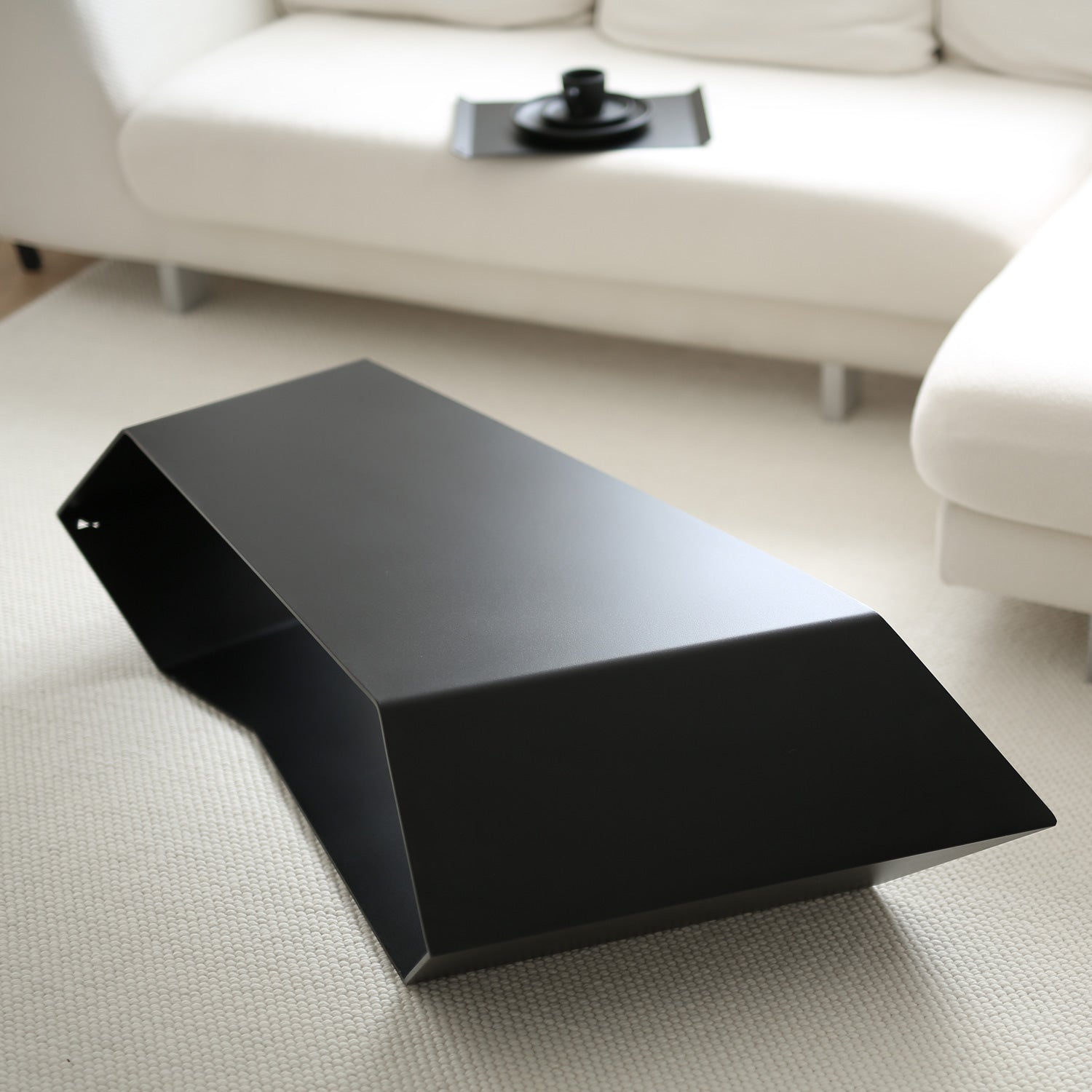 Angled view of Concordia black coffee table in its standard configuration
